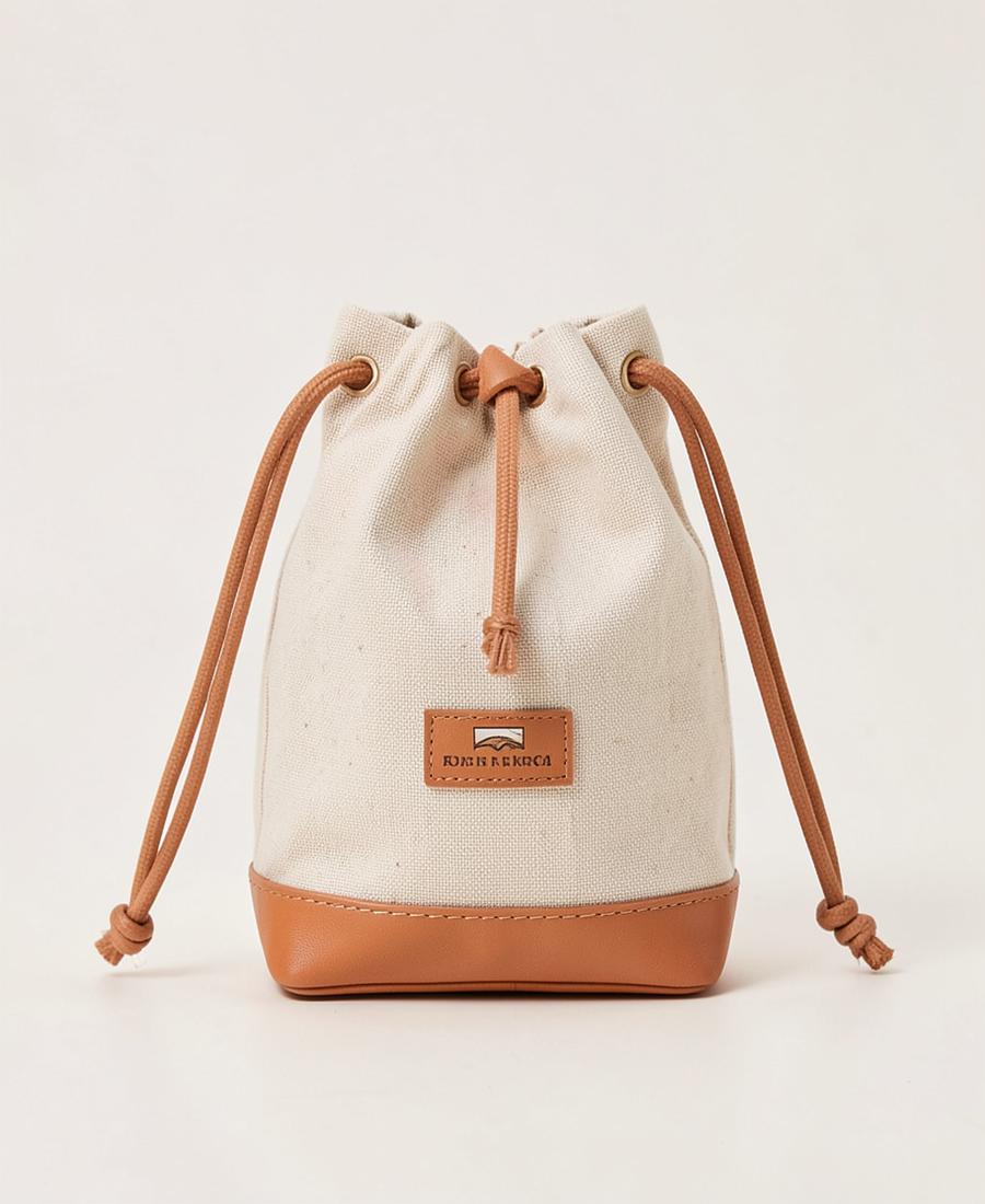 Cream canvas bucket bag with tan leather base
