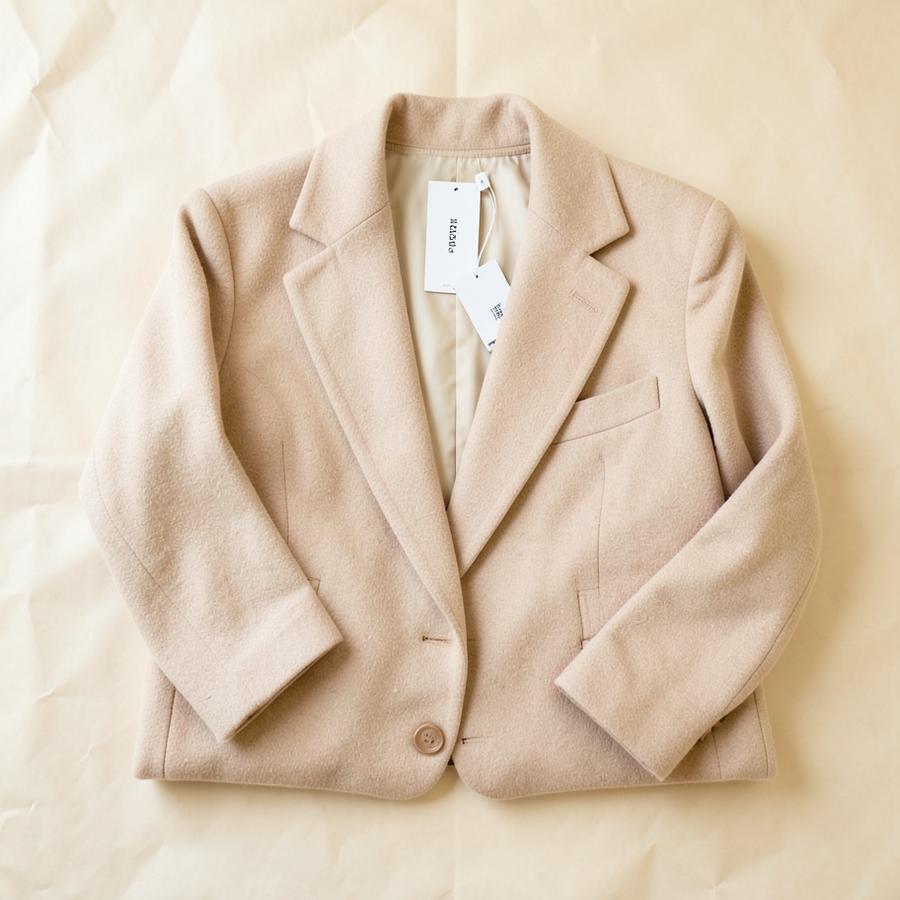 Beige oversized wool blazer folded flat